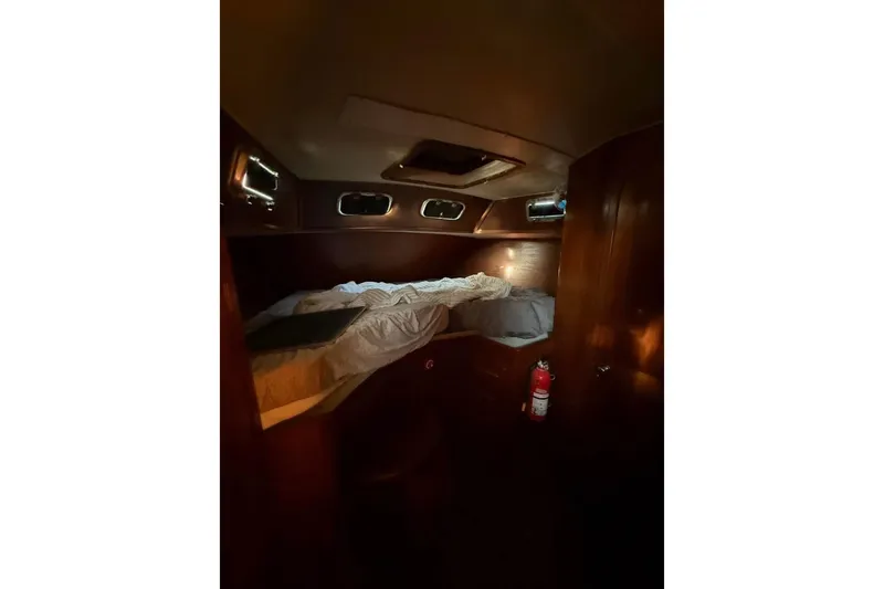 Slide: The Image of Cozy cabin interior of 1981 Gulfstar 44 Mk II Center Cockpit Sloop with bed and portholes. - 10