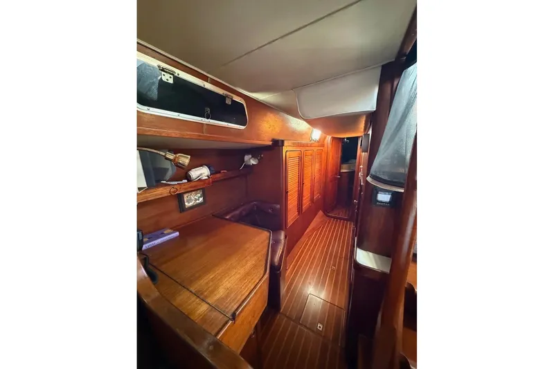 Slide: The Image of Interior of 1981 Gulfstar 44 Mk II Center Cockpit Sloop with wooden cabinetry and flooring. - 5