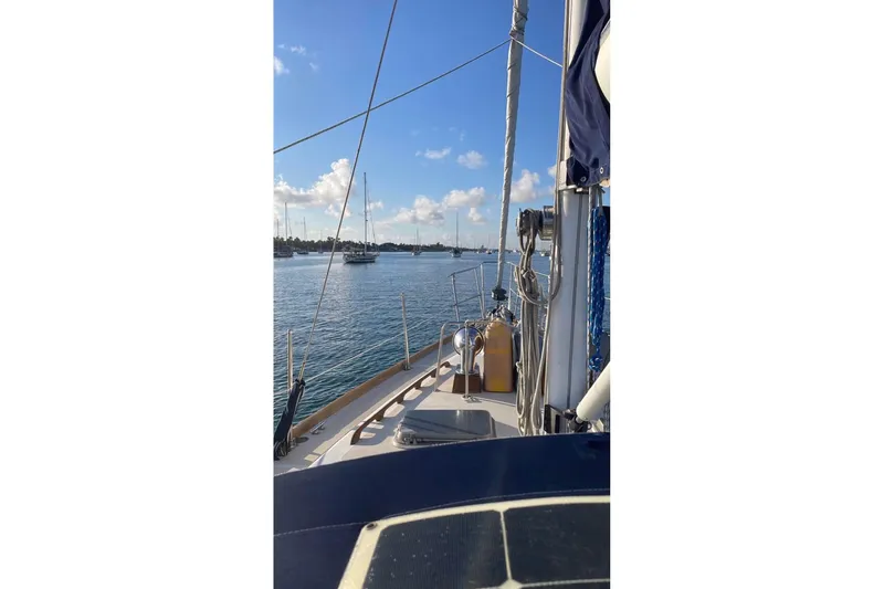 Slide: The Image of 1981 Gulfstar 44 Mk II Center Cockpit Sloop sailing on calm waters under a clear blue sky. - 9