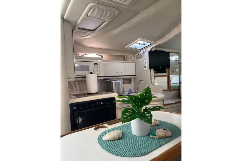 Slide: The Image of Interior of 1997 Sea Ray Sundancer 330 yacht with kitchen and decor elements. - 11