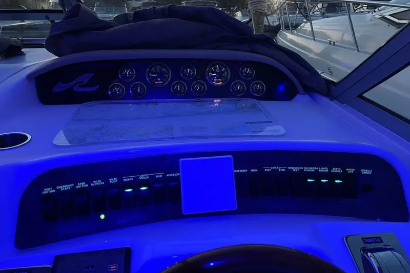 Slide: The Image of 1997 Sea Ray Sundancer 330 dashboard with illuminated gauges and controls at night. - 13