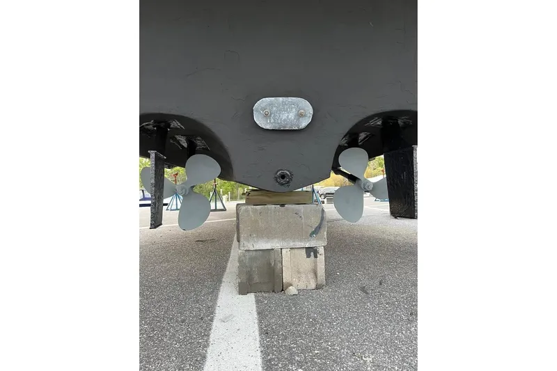 Slide: The Image of 1997 Sea Ray Sundancer 330 boat propellers and hull on concrete blocks. - 14