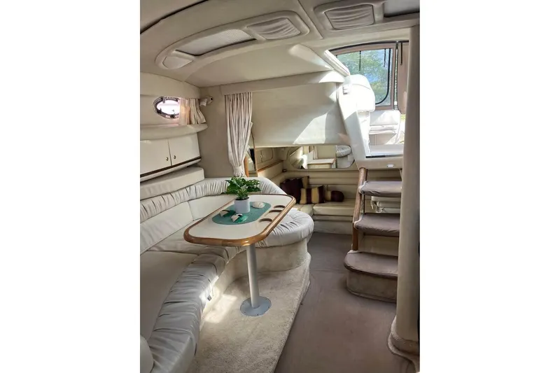 Slide: The Image of Interior of a 1997 Sea Ray Sundancer 330 yacht with cozy seating and elegant decor. - 8