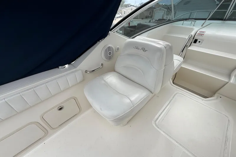 Slide: The Image of 2008 Sea Ray 270 Amberjack boat interior with white seating and steering area. - 10