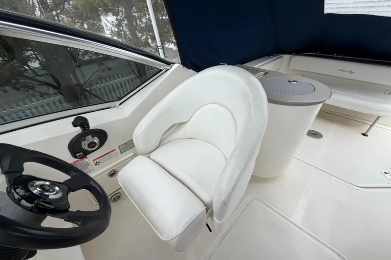 Slide: The Image of 2008 Sea Ray 270 Amberjack cockpit with white captain's chair and steering wheel. - 11