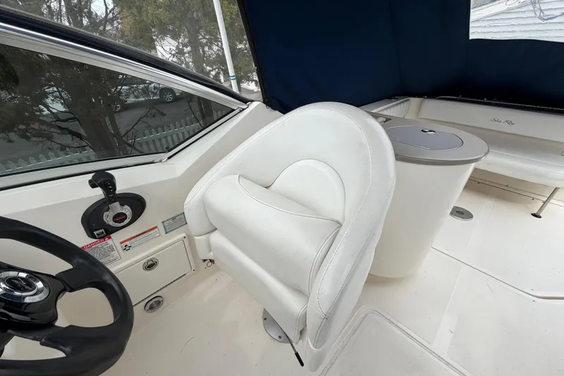 Slide: The Image of 2008 Sea Ray 270 Amberjack cockpit with white seating and steering wheel. - 12