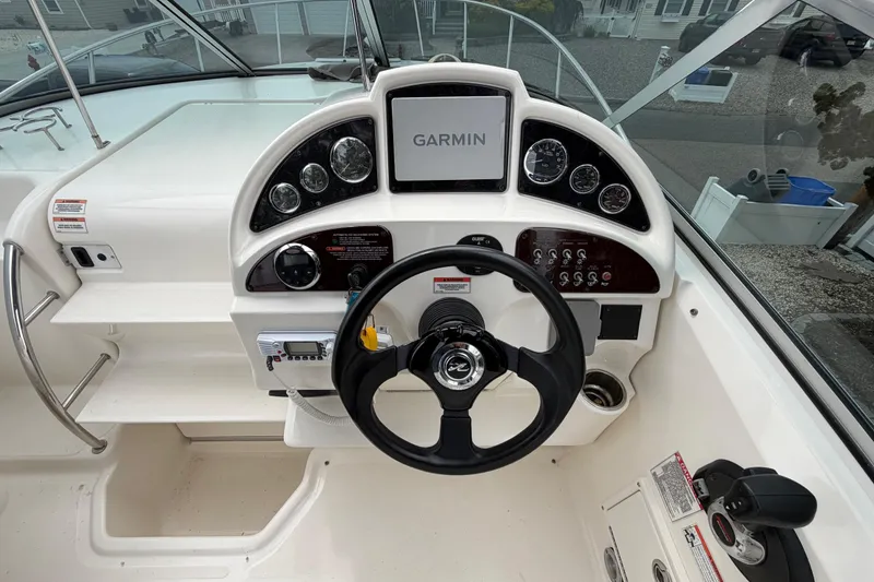 Slide: The Image of 2008 Sea Ray 270 Amberjack helm with Garmin navigation and sleek steering wheel. - 13