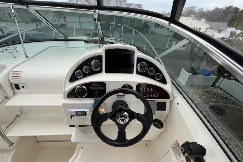 Slide: The Image of 2008 Sea Ray 270 Amberjack boat dashboard with steering wheel and instrument panel. - 14
