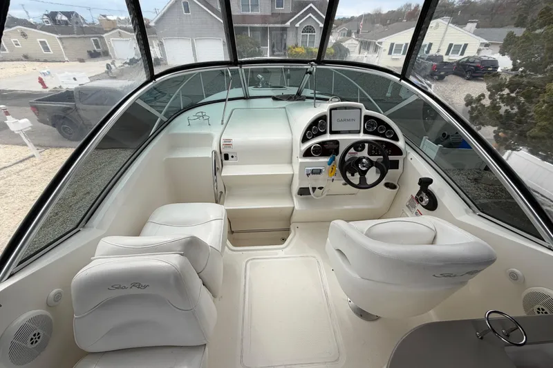 Slide: The Image of 2008 Sea Ray 270 Amberjack cockpit with Garmin navigation, white seating, and modern controls. - 15