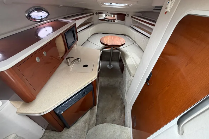 Slide: The Image of 2008 Sea Ray 270 Amberjack cabin interior with kitchenette and seating area. - 16