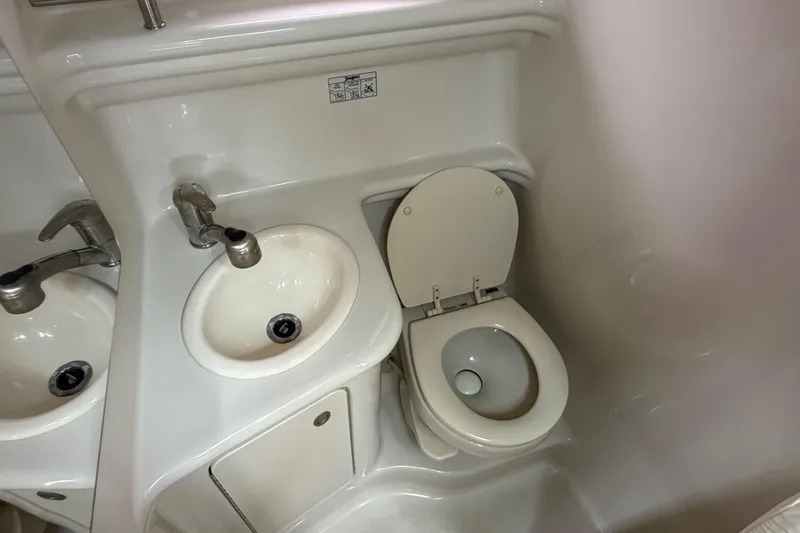 Slide: The Image of Compact bathroom in 2008 Sea Ray 270 Amberjack boat with sink and toilet. - 19