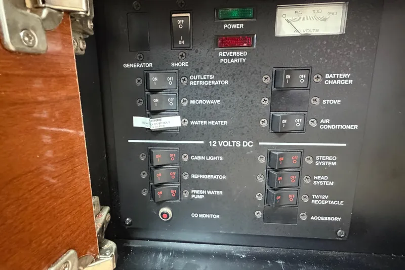 Slide: The Image of Control panel of a 2008 Sea Ray 270 Amberjack boat, featuring various electrical switches. - 23