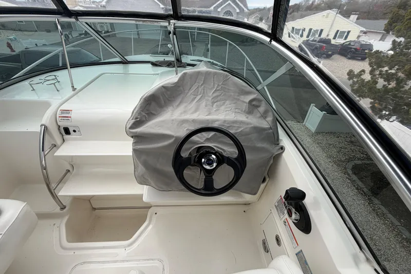 Slide: The Image of 2008 Sea Ray 270 Amberjack helm with covered steering wheel and spacious cockpit view. - 29