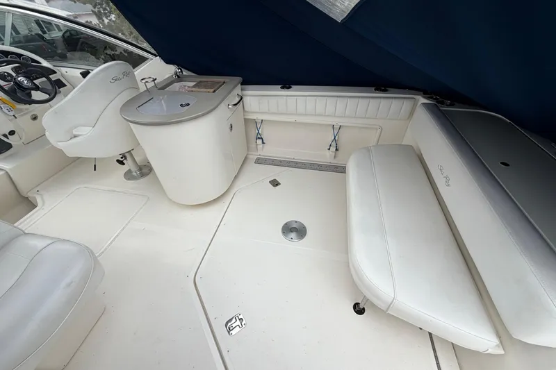 Slide: The Image of 2008 Sea Ray 270 Amberjack interior with white seating and helm station. - 7