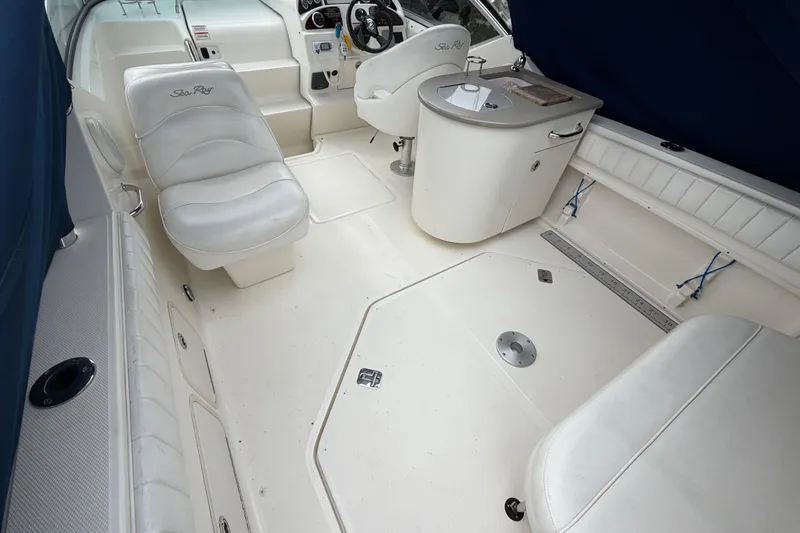 Slide: The Image of 2008 Sea Ray 270 Amberjack boat interior with white seating and helm station. - 8