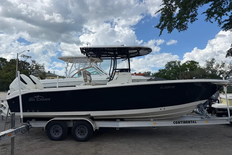 Slide: The Image of 2020 Sea Chaser 27 HFC CC boat on trailer under cloudy sky. - 1