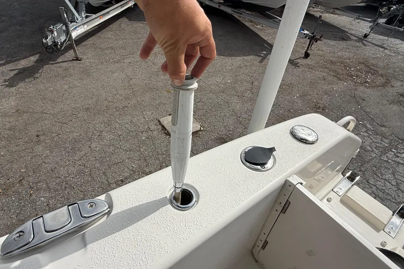 Slide: The Image of Hand adjusting rod holder on 2020 Sea Chaser 27 HFC CC boat deck. - 10