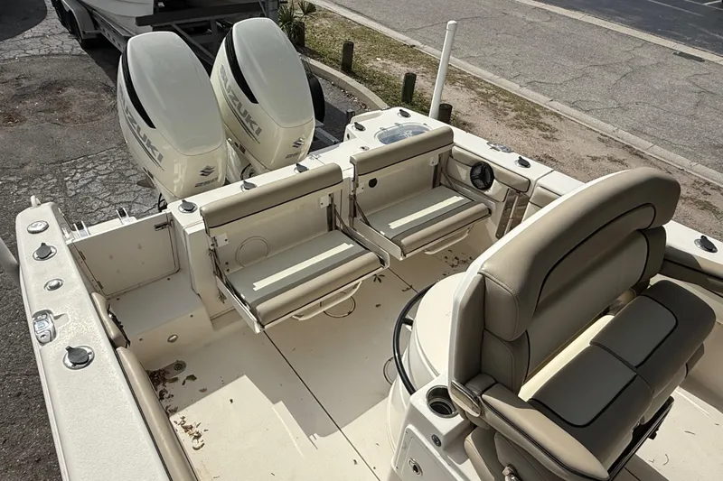 Slide: The Image of 2020 Sea Chaser 27 HFC CC boat interior with dual Suzuki engines and beige seating. - 13