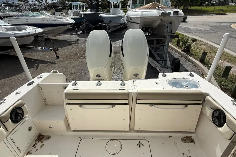 Slide: The Image of 2020 Sea Chaser 27 HFC CC boat with dual outboard motors in a marina setting. - 14