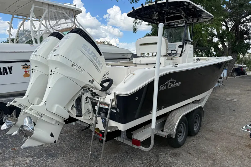 Slide: The Image of 2020 Sea Chaser 27 HFC CC boat with twin Suzuki outboard engines on a trailer. - 2
