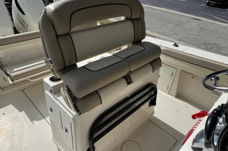 Slide: The Image of 2020 Sea Chaser 27 HFC CC boat interior with cushioned seating and steering wheel. - 21