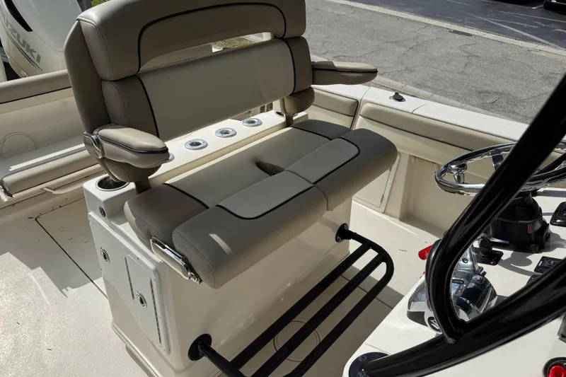 Slide: The Image of 2020 Sea Chaser 27 HFC CC boat interior with cushioned seating and steering wheel. - 22