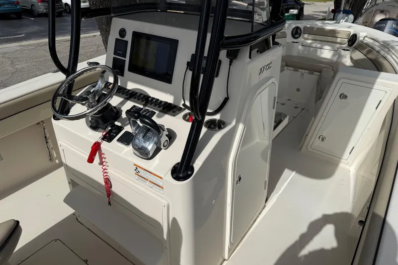 Slide: The Image of 2020 Sea Chaser 27 HFC CC boat interior with steering console and controls. - 24