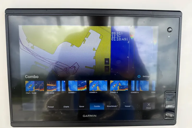 Slide: The Image of Garmin marine display on 2020 Sea Chaser 27 HFC CC showing navigation and sonar data. - 26
