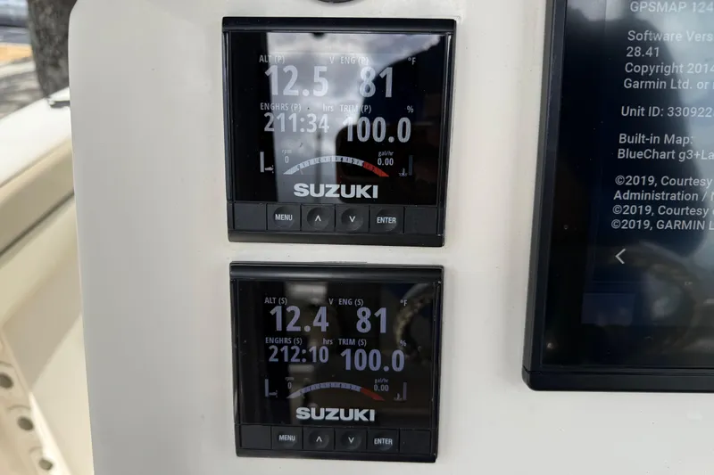 Slide: The Image of Digital displays on a 2020 Sea Chaser 27 HFC CC boat showing engine data. - 28