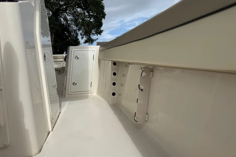 Slide: The Image of 2020 Sea Chaser 27 HFC CC boat interior with storage compartments and rod holders. - 32