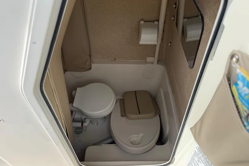 Slide: The Image of 2020 Sea Chaser 27 HFC CC boat interior bathroom with toilet and storage. - 34