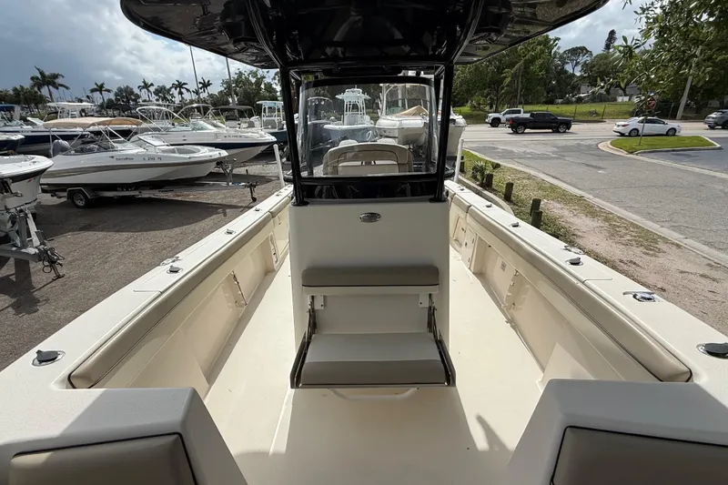 Slide: The Image of 2020 Sea Chaser 27 HFC CC boat interior at a marina with parked boats. - 37