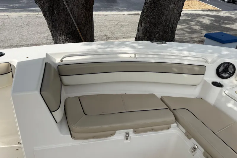 Slide: The Image of 2020 Sea Chaser 27 HFC CC boat interior with cushioned seating and cup holder. - 39