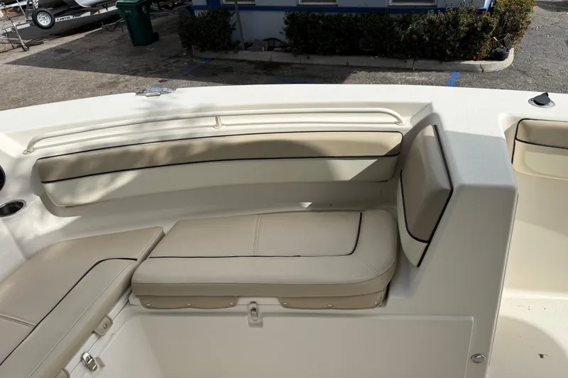 Slide: The Image of 2020 Sea Chaser 27 HFC CC boat interior with beige seating and cup holders. - 40