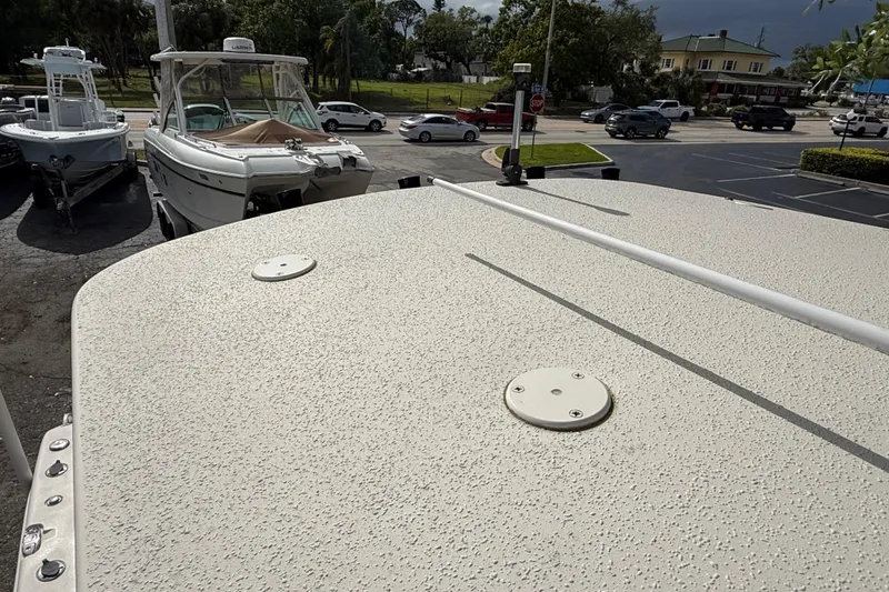 Slide: The Image of 2020 Sea Chaser 27 HFC CC boat deck in a parking lot with other boats. - 44