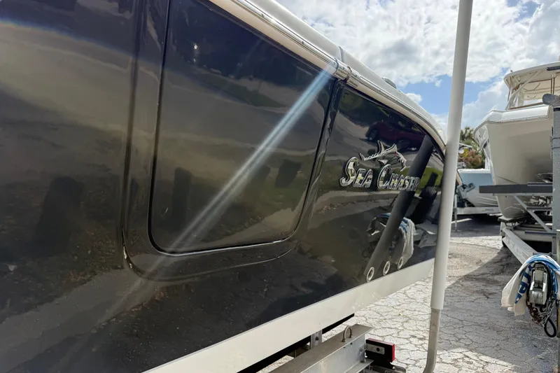 Slide: The Image of 2020 Sea Chaser 27 HFC CC boat on trailer, side view with logo visible. - 5