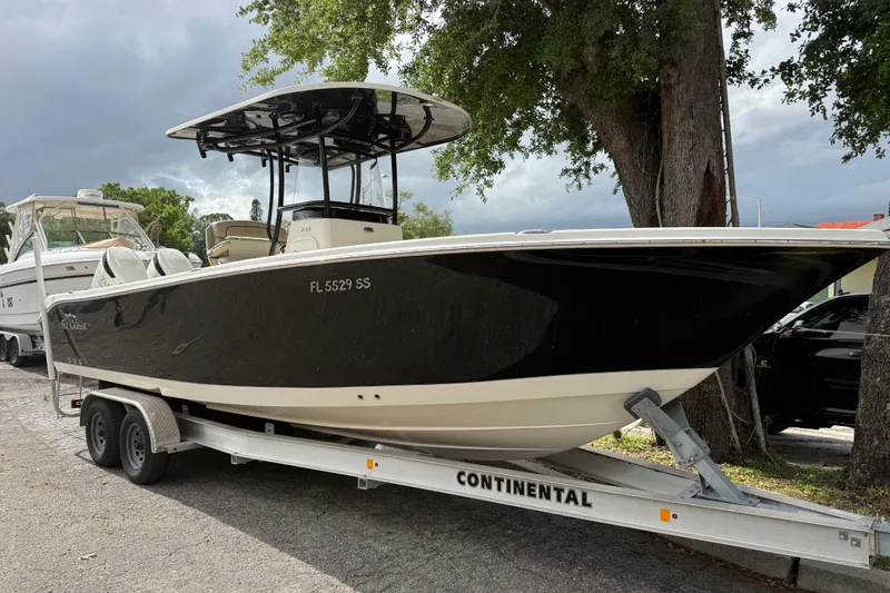 Slide: The Image of 2020 Sea Chaser 27 HFC CC boat on trailer, parked under a tree. - 7