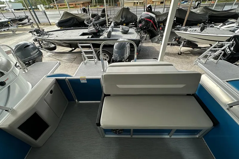 Slide: The Image of Sweetwater EX2086SFLX 2026 pontoon boat interior with seating and motor view. - 16