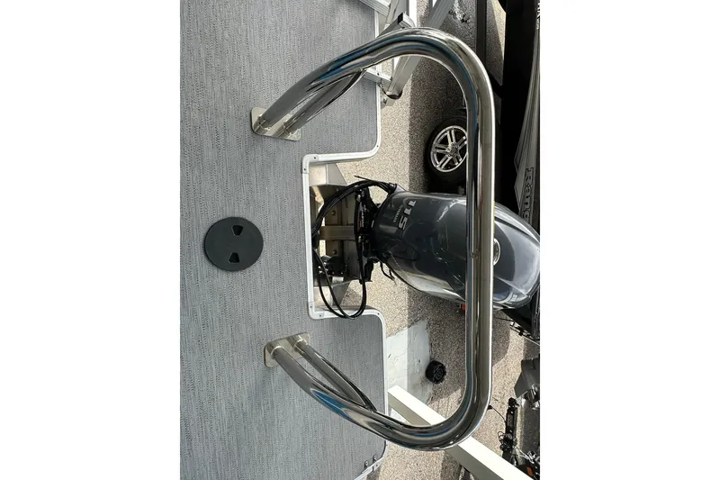 Slide: The Image of Sweetwater EX2086SFLX 2026 boat deck with stainless steel railing and motor. - 20