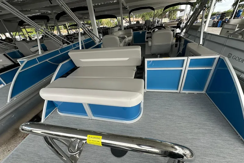 Slide: The Image of 2026 Sweetwater EX2086SFLX pontoon boat interior with blue panels and beige seating. - 22