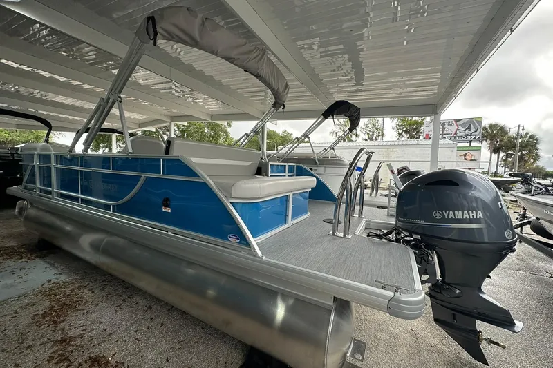 Slide: The Image of 2026 Sweetwater EX2086SFLX pontoon boat with Yamaha motor, under covered storage. - 24