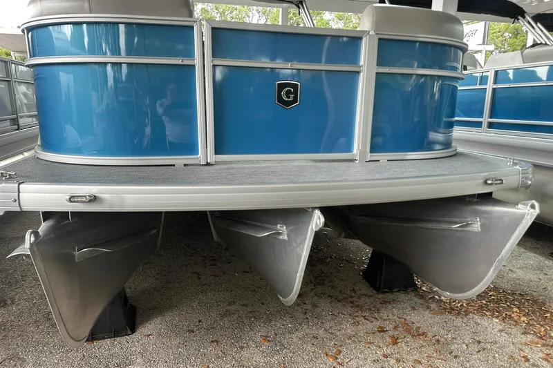 Slide: The Image of 2026 Sweetwater EX2086SFLX pontoon boat with blue exterior and triple aluminum pontoons. - 3