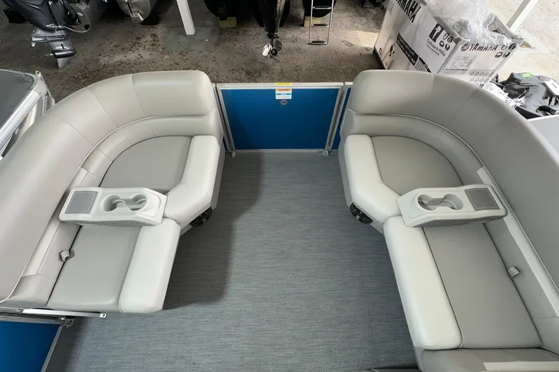 Slide: The Image of 2026 Sweetwater EX2086SFLX boat interior with gray seating and cup holders. - 4