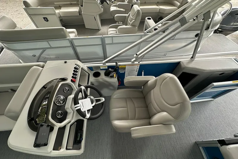 Slide: The Image of 2026 Sweetwater EX2086SFLX boat interior with steering console and plush seating. - 7
