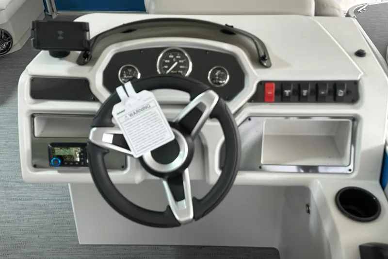 Slide: The Image of Steering console of 2026 Sweetwater EX2086SFLX boat with gauges and controls. - 9