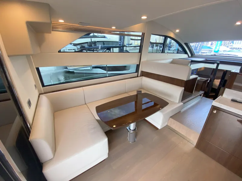 Slide: The Image of Interior of Fairline Squadron 50 yacht, 2024 model, featuring elegant seating area. - 10