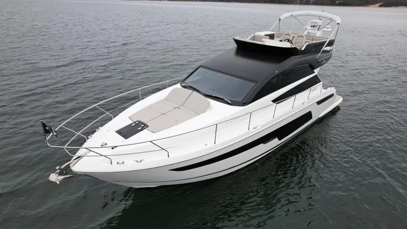 Slide: The Image of 2024 Fairline Squadron 50 luxury yacht on open water. - 2
