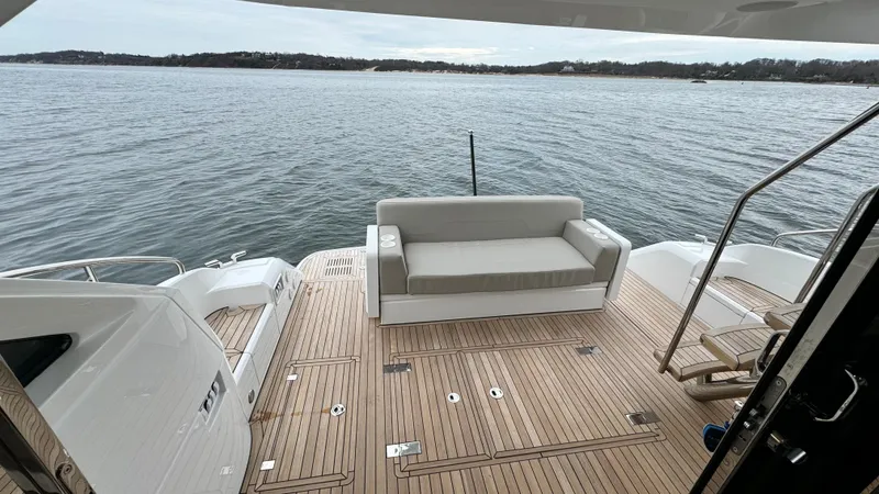 Slide: The Image of Fairline Squadron 50 2024, luxurious deck with sofa, overlooking the water. - 23
