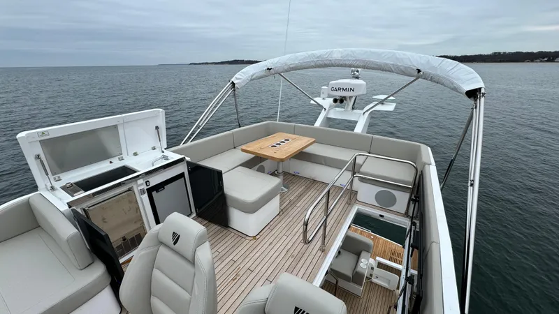 Slide: The Image of 2024 Fairline Squadron 50 yacht with spacious deck on calm sea. - 29