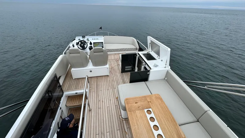Slide: The Image of 2024 Fairline Squadron 50 yacht with spacious deck on open sea. - 31